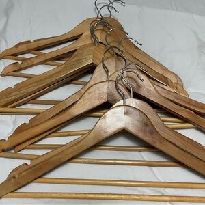 Eleven wooden hangers with dress notches